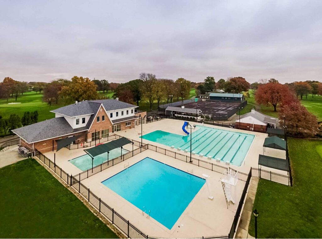 Aerial view of large outdoor pool facility with two rectangular pools — commercial swimming pool complex design.