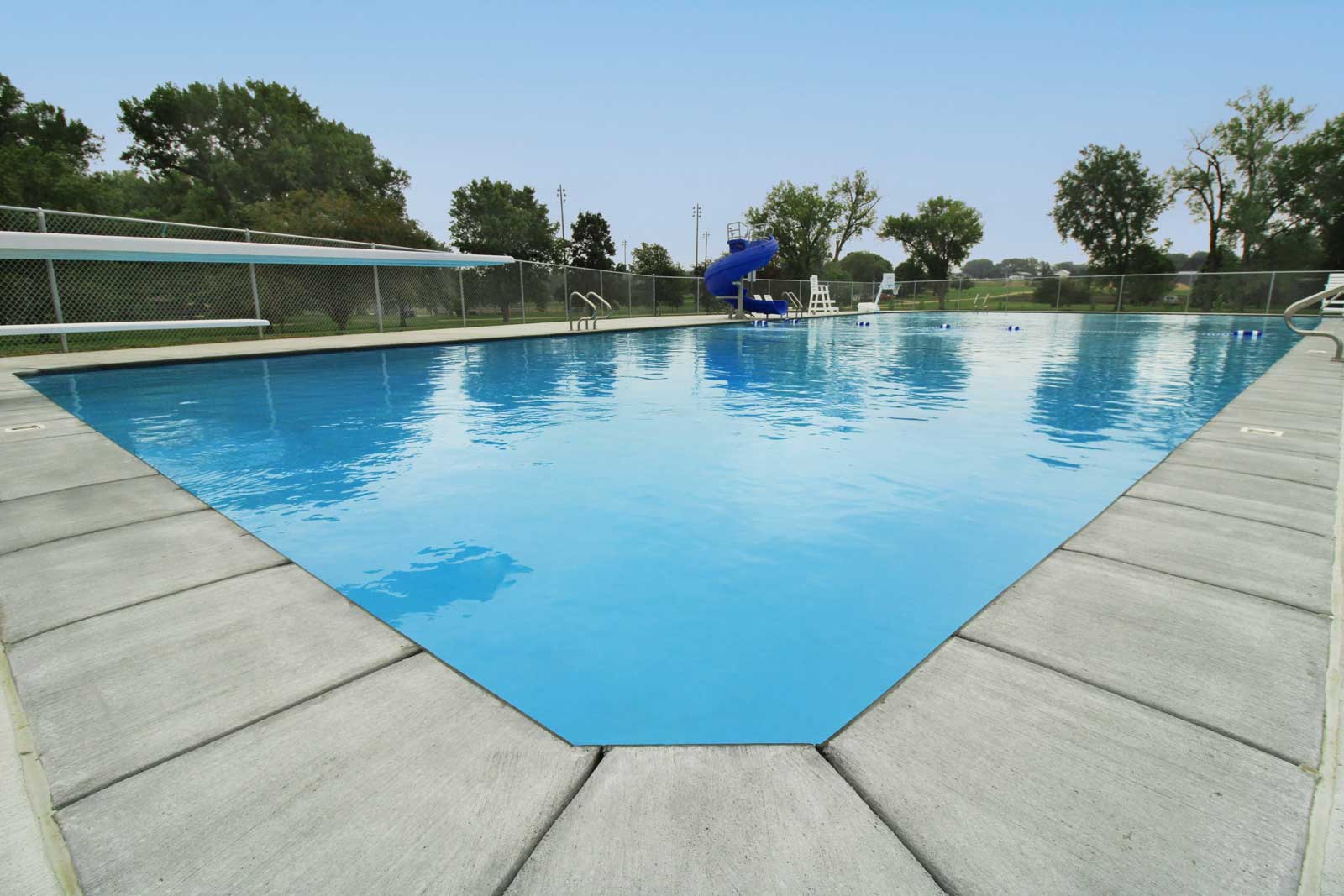 Outdoor pool with water feature and landscaping — decorative pool renovation and design