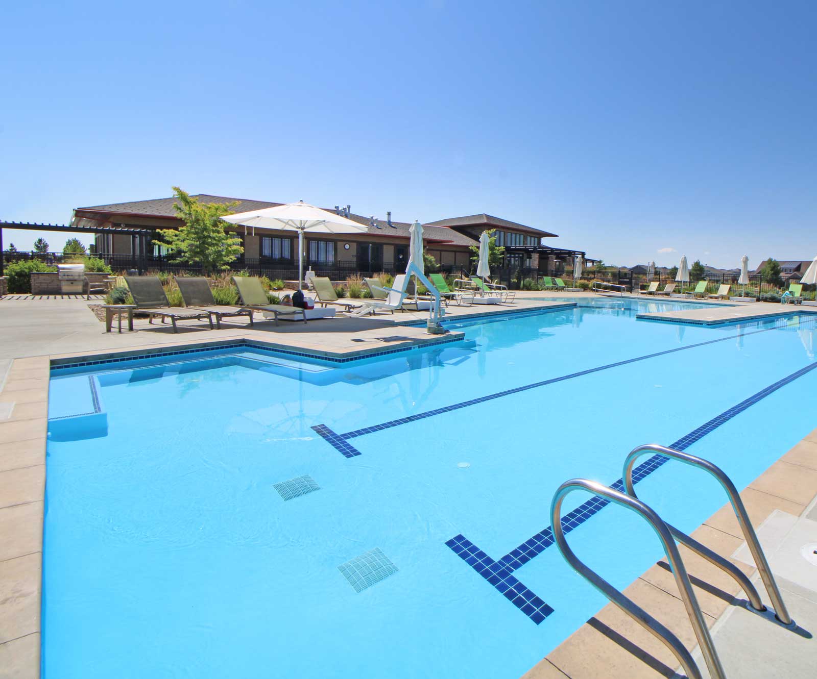 Swimming pool with lane markings and poolside furniture — competitive pool facility maintenance and design