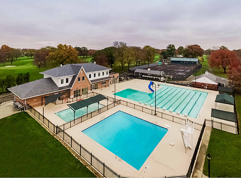Aerial view of pool facility with rectangular pools and surrounding buildings — commercial pool architecture and planning.