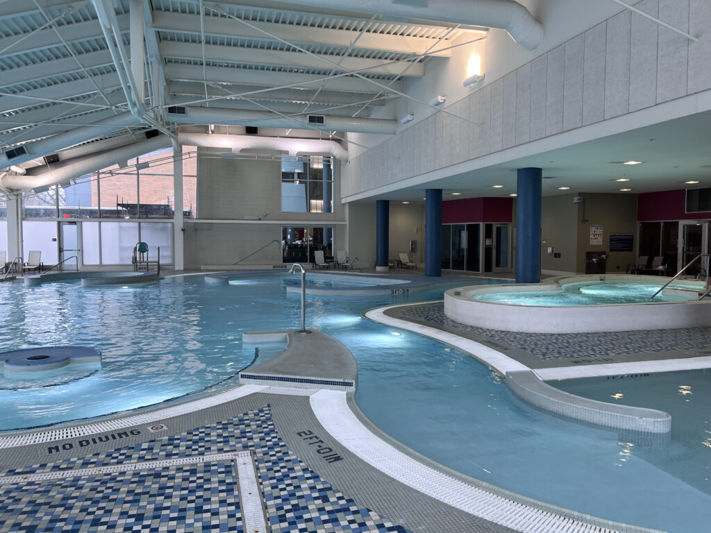 After - Half of pool with lazy river and benches